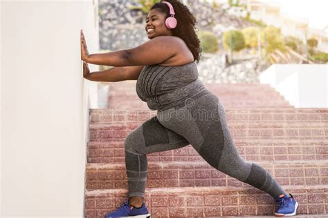 Curvy African Woman Doing Sport Workout Routine Outdoor In The City Focus On Face Stock Image