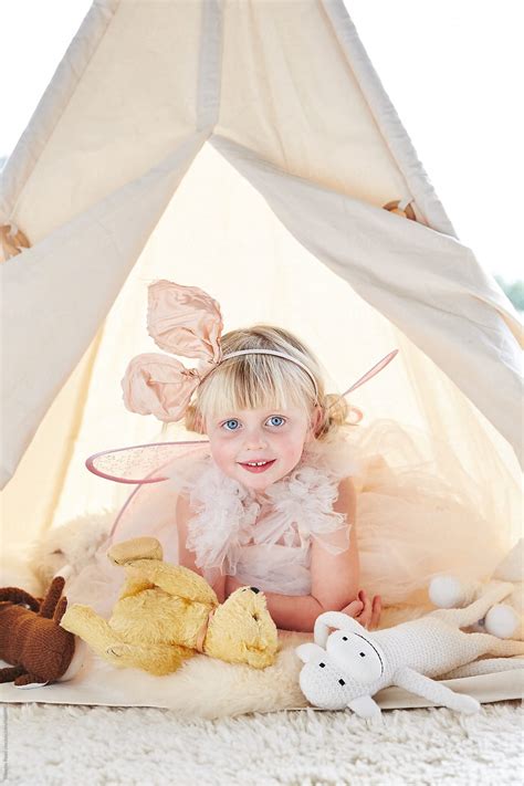 Portrait Of Cute Little Girl Playing Dress Up In Tent By Stocksy