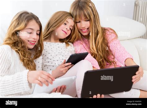 Three Kid Sister Friends Girls Group Playing Together With Tablet Pc On