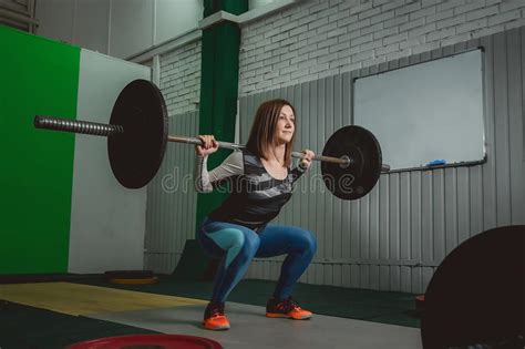 Strong Woman Lifting Barbell As A Part Of Crossfit Exercise Routine