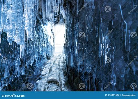 Winter Landscape Frozen Ice Cave With Bright Sunlight From Way Out At