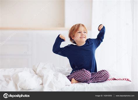 Peppy Young Boy Waking Up In The Morning Stock Photo By ©olesiabilkei