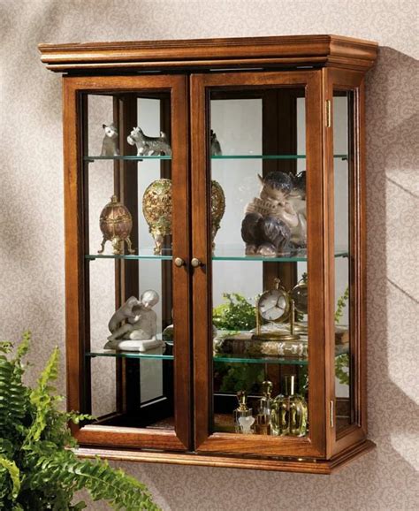 This elegant cabinet, with its clean, strong lines, is as much a work of art as the objects that you display in it. Hanging Lighted Corner Curio Cabinet — Ideas Roni Young ...