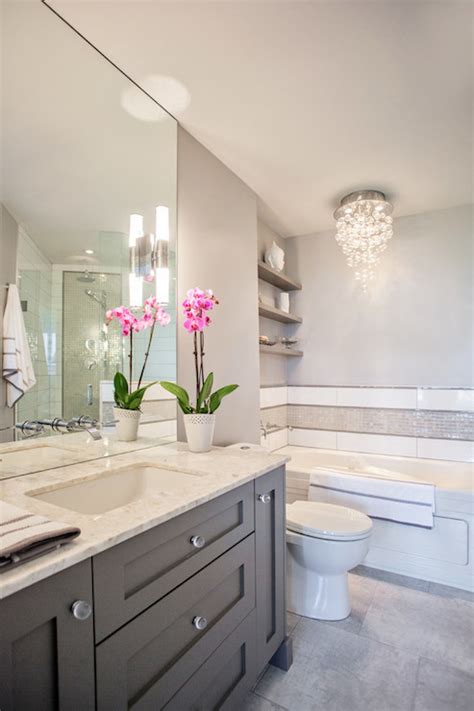 Sconce lighting on either side of the mirror offers the best light for getting ready and looking at your reflection. Madison Taylor Design - bathrooms - white and grey bath ...