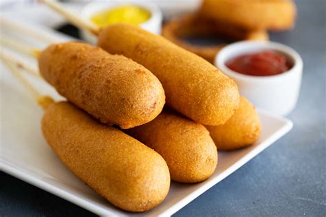 Hot dogs dipped in a honey cornmeal batter and fried until crispy!! Homemade Corn Dog Recipe - Taste and Tell