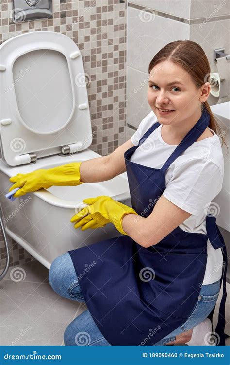 A Lovely Girl From A Cleaning Service Washes A Toilet In A Hotel Stock