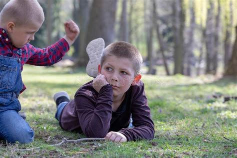 Two Young Brothers Quarreling In The Park Stock Photo Image Of