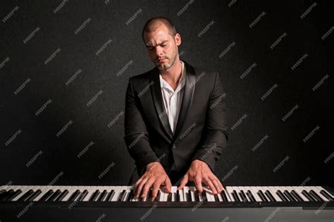 Free Photo Passionate Musician Playing Chords On Piano In Studio