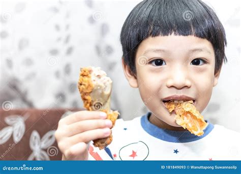 Hungry Asia Little Boy Eating Chicken Leg Child Hand Holding A Fried
