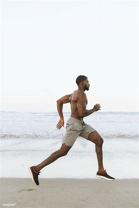 Download Premium Image Of Fit Man Running At The Beach In The Early