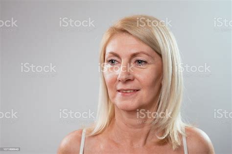 portrait of beautiful blonde mature 55 year old woman with perfect natural skin in underwear