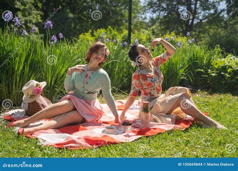 Two Pretty Pin Up Ladies Having Nice Picnic In The City Park In A Sunny Day Together Girls