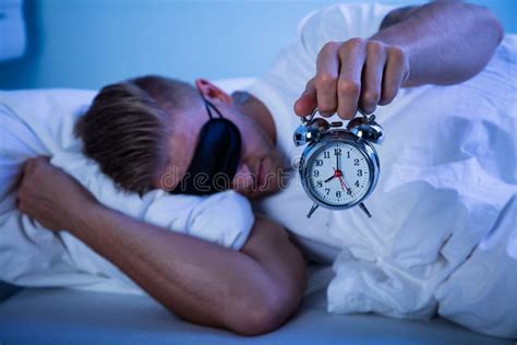 Man Sleeping With A Alarm Clock In His Hand Stock Photo Image Of