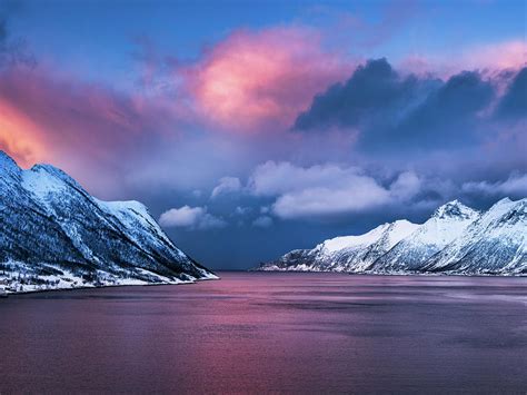 Ersjordbotn View With Dramatic Cloudscape Above Snowcapped Mountain