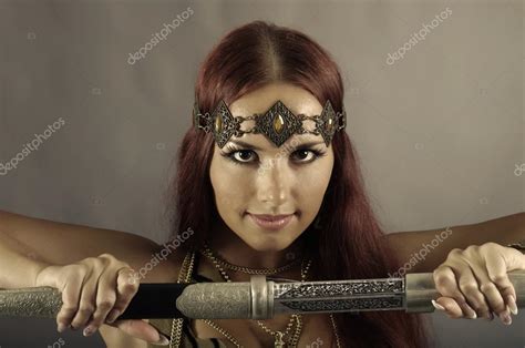 Warrior Woman Holding Sword In Her Hand — Stock Photo © Fanfon 53891639