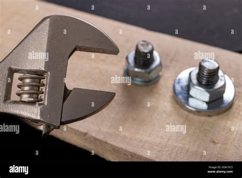Metal Bolts And Nuts For Joining Wood Tightening The Screws With An