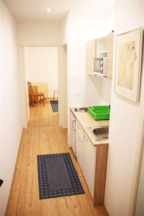 There is a full a kitchen with a dishwasher and a coffee machine. FAIRSCHLAFEN - Apartmenthaus Leipzig Wohnung #3 ...