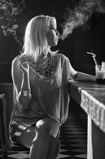 Elegant Woman Smoking Cigarette And Drinking In The Bar Stock Photo