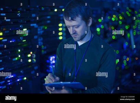 Server Room Technician Taking Notes On Clipboard Stock Photo Alamy