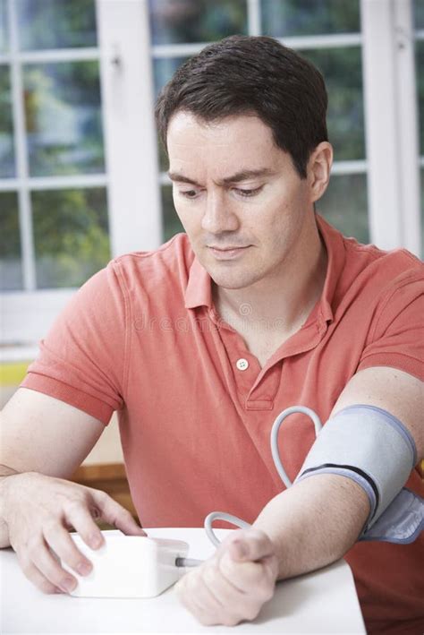Man Measuring Blood Pressure At Home Stock Photo Image Of Measuring