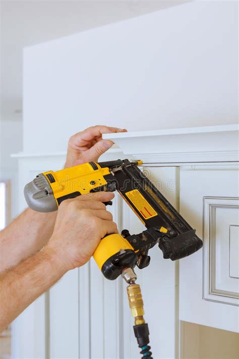 Why i built my diy cabinets using only plywood. Carpenter Brad Using Nail Gun To Crown Moulding On Kitchen Cabinets Framing Trim, Stock Image ...