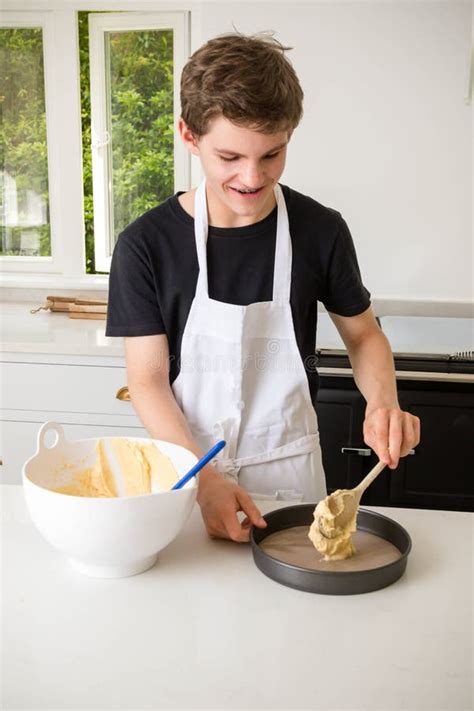 A Teenage Boy Cooking In A Kitchen Stock Photo Image Of Preparation