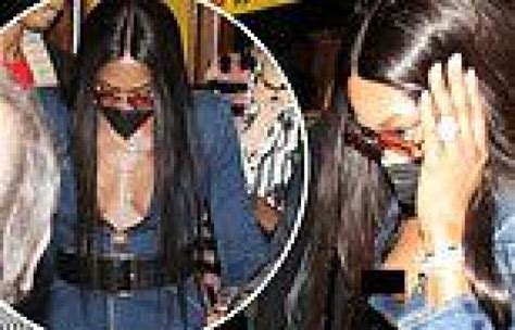 naomi campbell 51 suffers a nip slip while going braless in a plunging denim