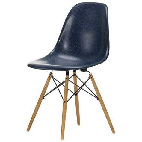 The back and seat of these chairs are made of a single piece of molded fiberglass contoured to the shape of the human body. Vitra Eames DSW Fiberglass Chair, navy blue - maple | Finnish Design Shop
