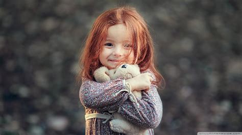 Smiley Cute Little Girl Is Holding Toy In Hand Wearing