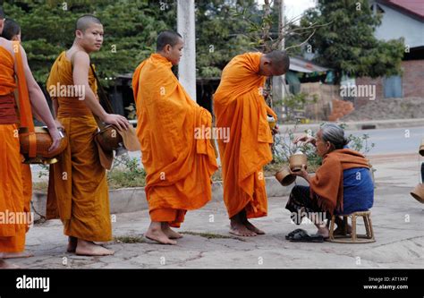 Monks And Novices On Alms Round Vientiane Laos Stock Photo Alamy