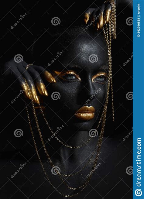 Beauty Woman Painted In Black Skin Color Body Art Gold Chain In His Hands And Around His Neck
