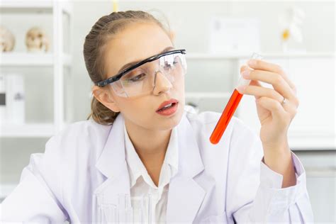 A Beautiful Female Scientist Is Operating In A Science Lab With Various Equipment In The Lab