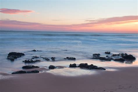 Beautiful Calming Sunrise Vacation Landscape Warm Colors Rocks On Shore