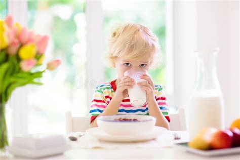 Child Eating Breakfast Kid With Milk And Cereal Stock Image Image Of