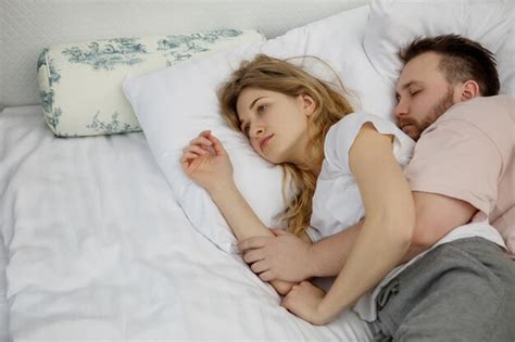 Premium Photo Man Embracing Woman While Sleeping On Bed At Home