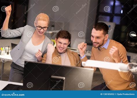 Business Team Celebrating Success At Night Office Stock Photo Image