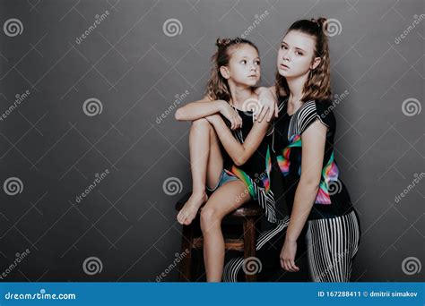 Two Fashionable Girls Sisters In Beautiful Clothes Portrait Stock Image