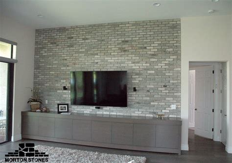 These bricks are organized in an very irregular pattern. Example of a modern living room decorated with gray brick ...