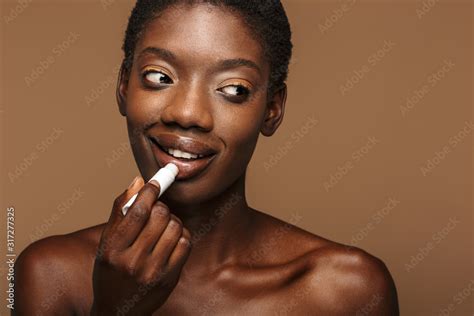 Beauty Portrait Of Young Half Naked African Woman Putting On Lipbalm