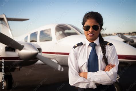Female Pilot Standing In Front Of Her Aircraft Stock Photo Adobe Stock
