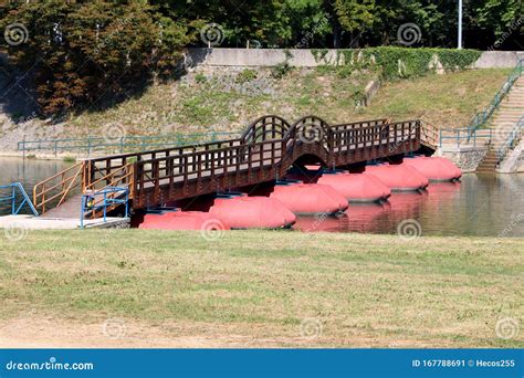 New Wooden Floating Pontoon Bridge With Strong Red Floats And Center
