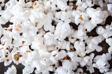 Close Up Of Popcorn Spilled Out On A Wooden Table With Selective Stock