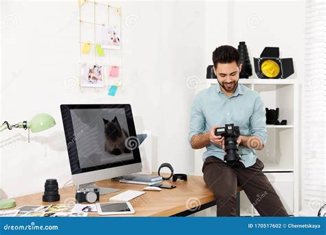Professional Photographer With Camera Working In Modern Office Stock