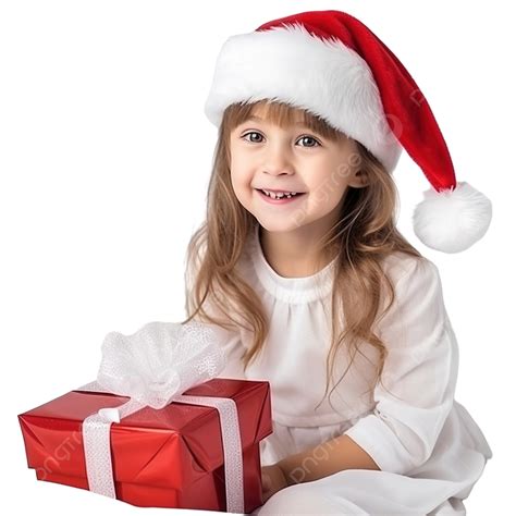 Happy Little Girl In Santa Claus Hat Sits On The Bed With A Christmas