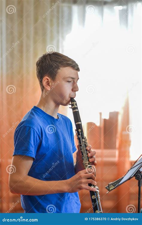 The Guy Plays The Clarinet Looks At The Music And Plays Music In A