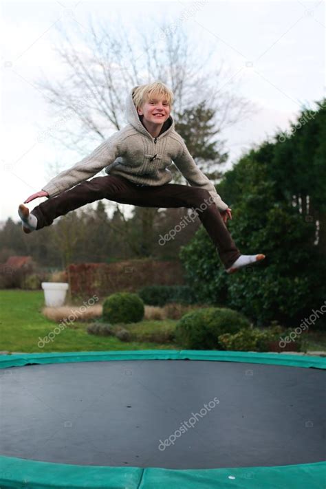 Happy Boy Jumping On Trampoline — Stock Photo © Cromary 113827488