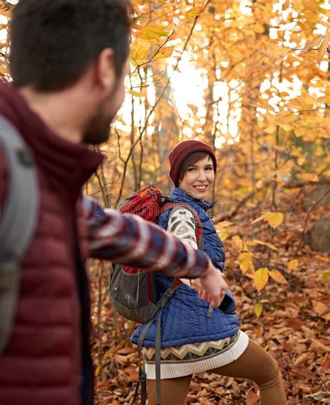 pov picture of an attractive caucasian couple hiking through the forest in the fall in canada