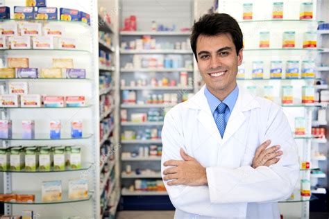Portrait Of A Male Pharmacist At Pharmacy Stock Photo By ©mangostock