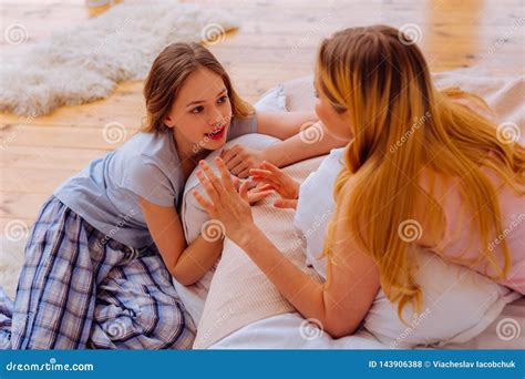 Loving Blonde Haired Sister Talking To Her Cute Blue Eyed Sibling Stock