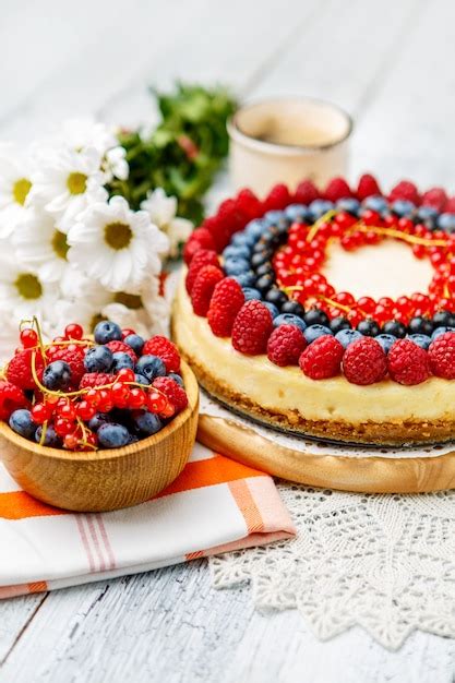 Premium Photo Raspberry And Blueberry Cheesecake On Wooden Table